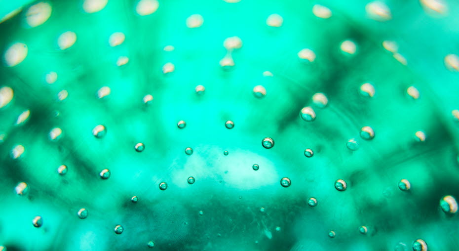 A green glass plate with a bubbly pattern.