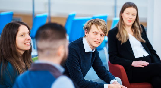 Four people sit down and talk to each other.