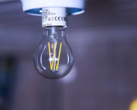 A light bulb hangs from the ceiling