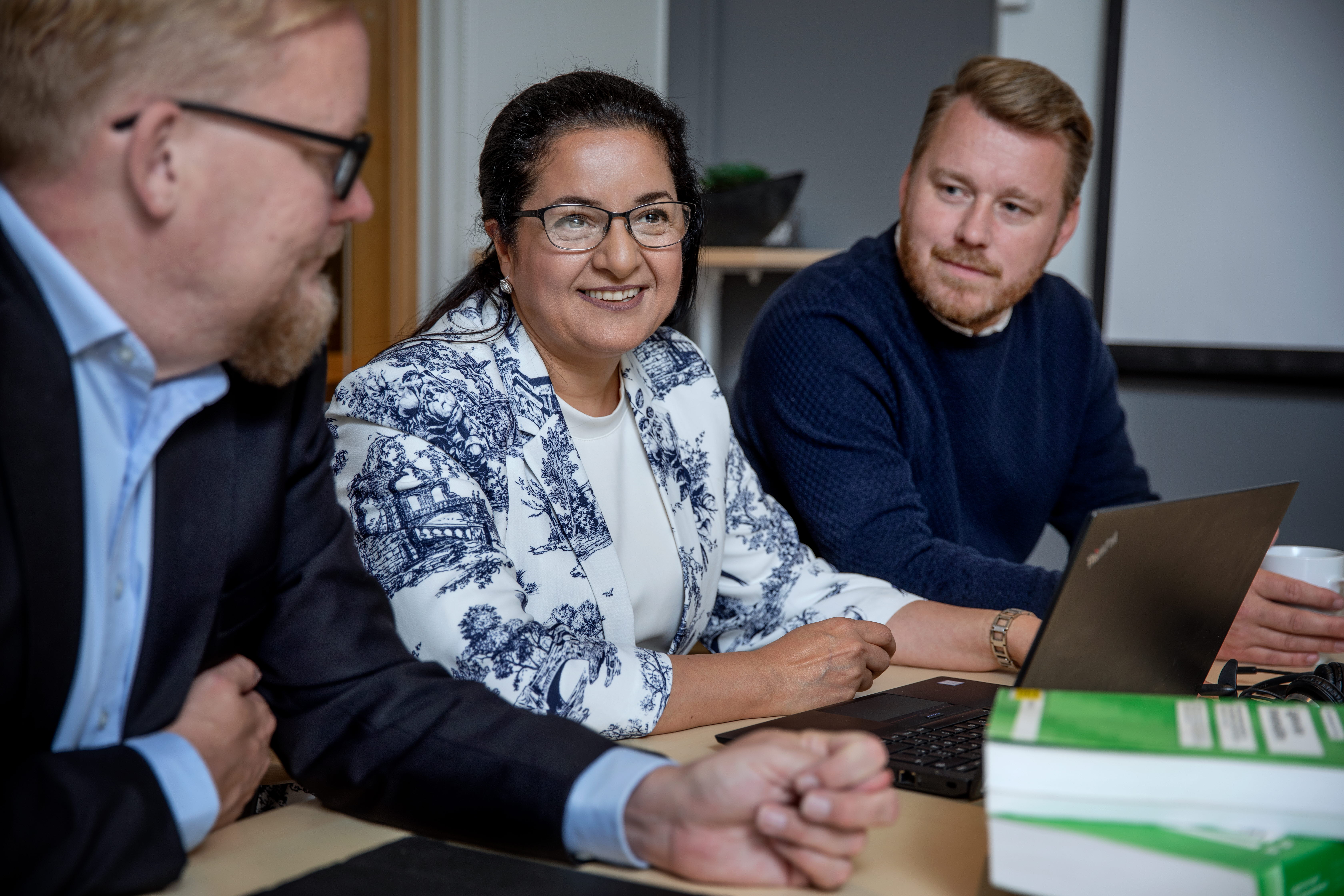 Människor som sitter i ett konferensrum och pratar