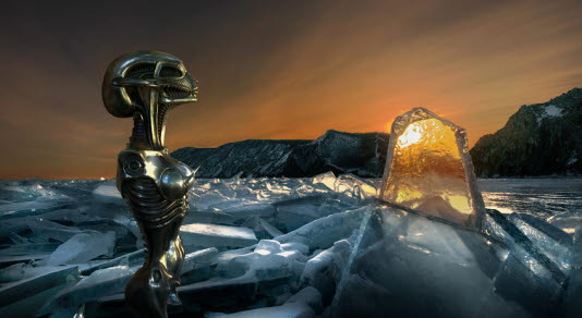 A futuristic image of a robot gazing at the sunset over a mountain ridge.